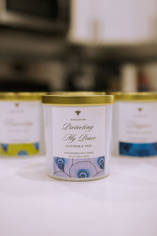 This is a 8.5 ounce Lavender Sage & Vanilla scented soy candle in a white jar white a purple label.